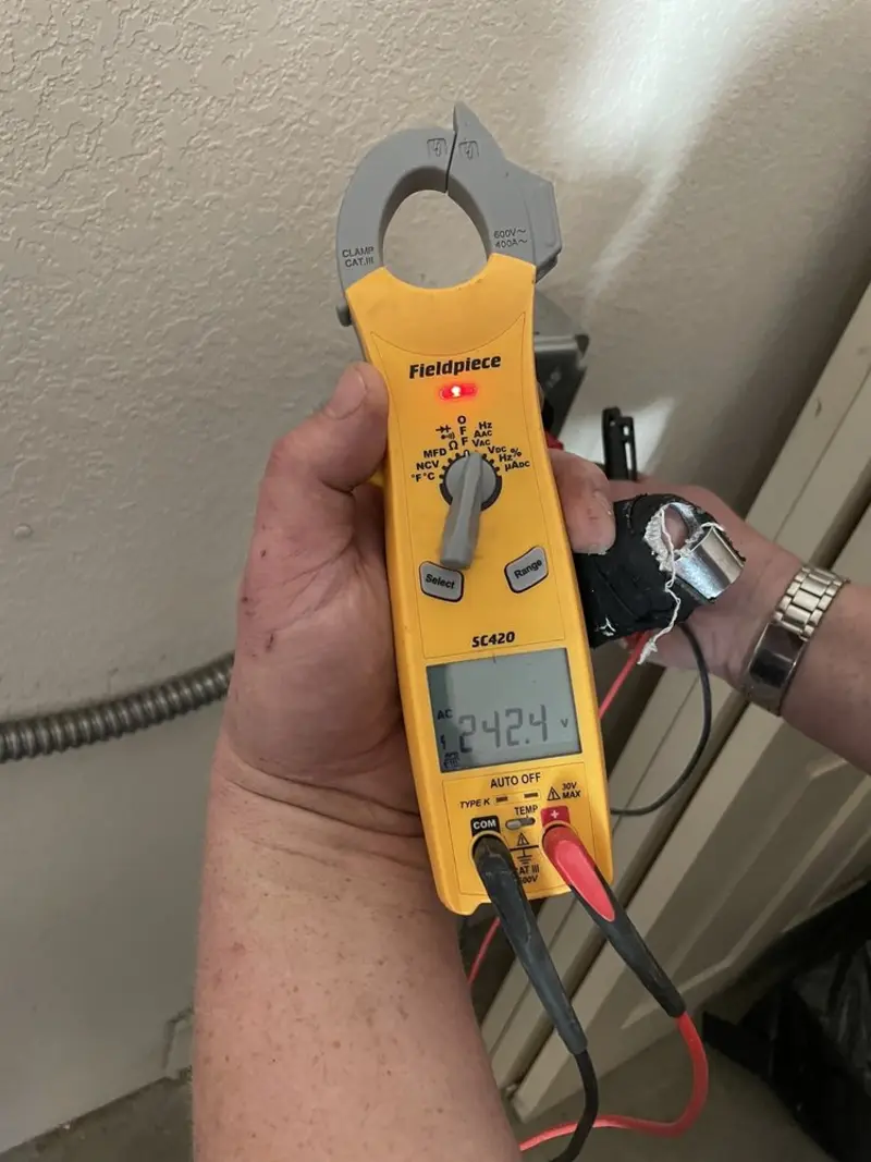 Voltage testing with clamp meter during Electrical Installation Services in Quincy